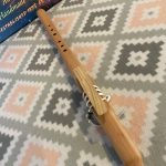 The reed piece is tied down uniquely with soft deerskin lace adorned with silver plated beads.